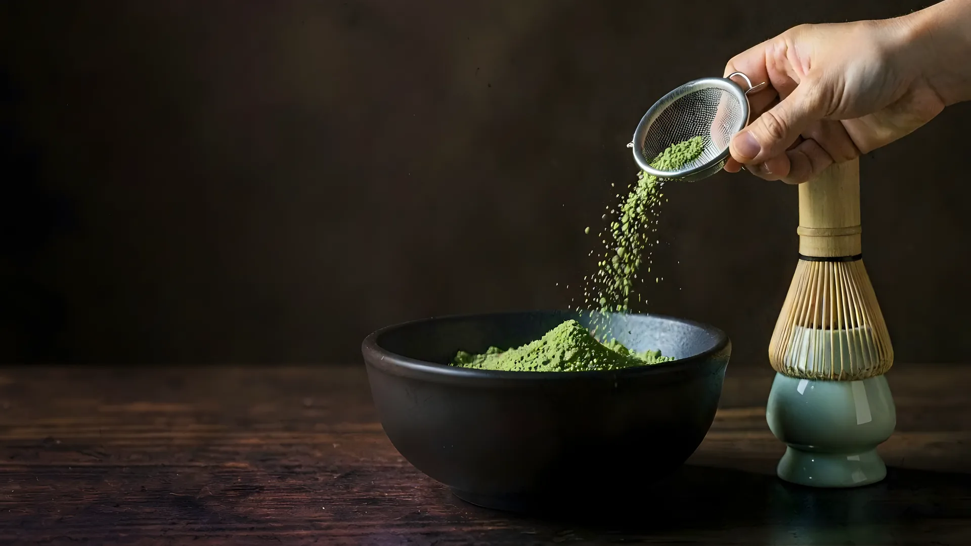 Hot water poured onto matcha in a bowl and whisked to a fine foam